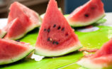 Slices of watermelon on a cutting board.